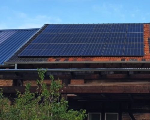 Solarmodule auf einem roten Dach.