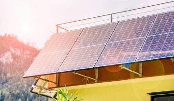Detail of solar panels around a roof terrace of a house in the mountains. Concept of renewable energy.